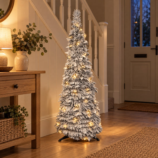 4ft frosted pop-up Christmas tree with warm white lights in a British hallway