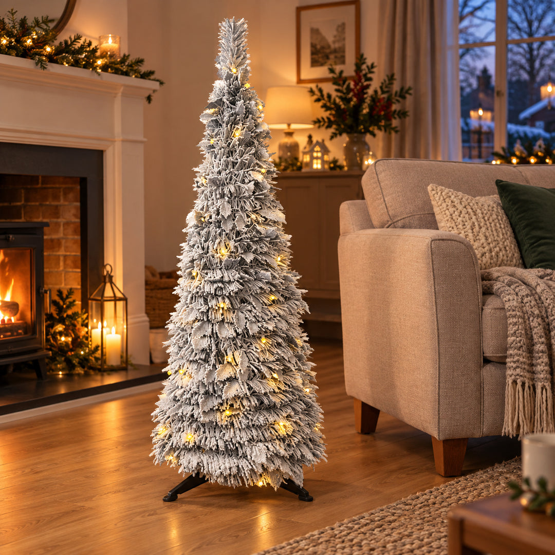 4ft frosted pop-up Christmas tree with warm white lights in a British living room