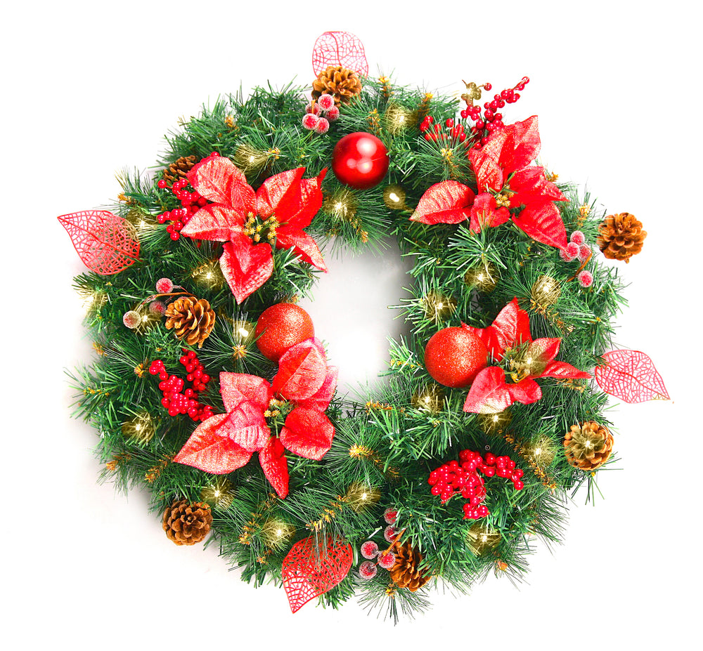 A decorated artificial Christmas wreath with LED lights, pine branches, red flowers, berries, and metallic ornaments.